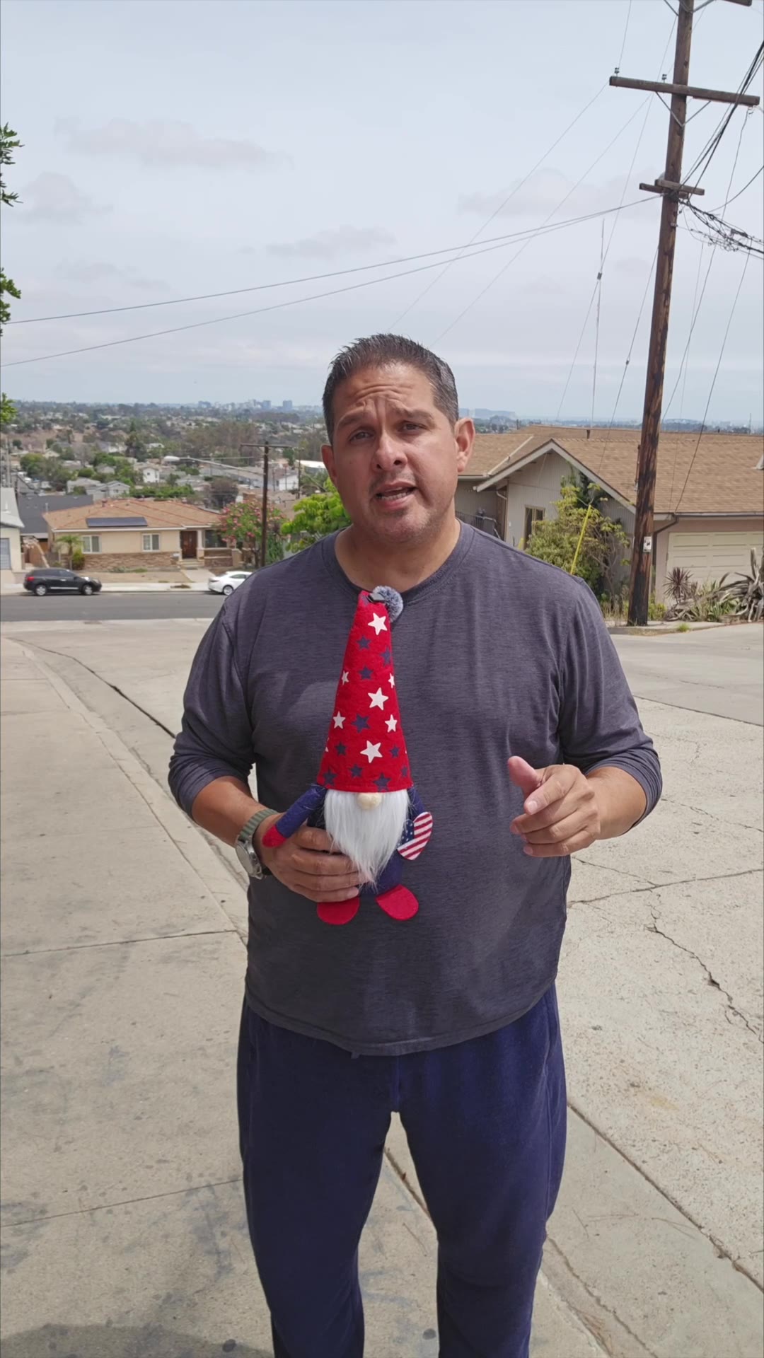 John on day 13 of the 90 day water fast, outside on the street with the gnome